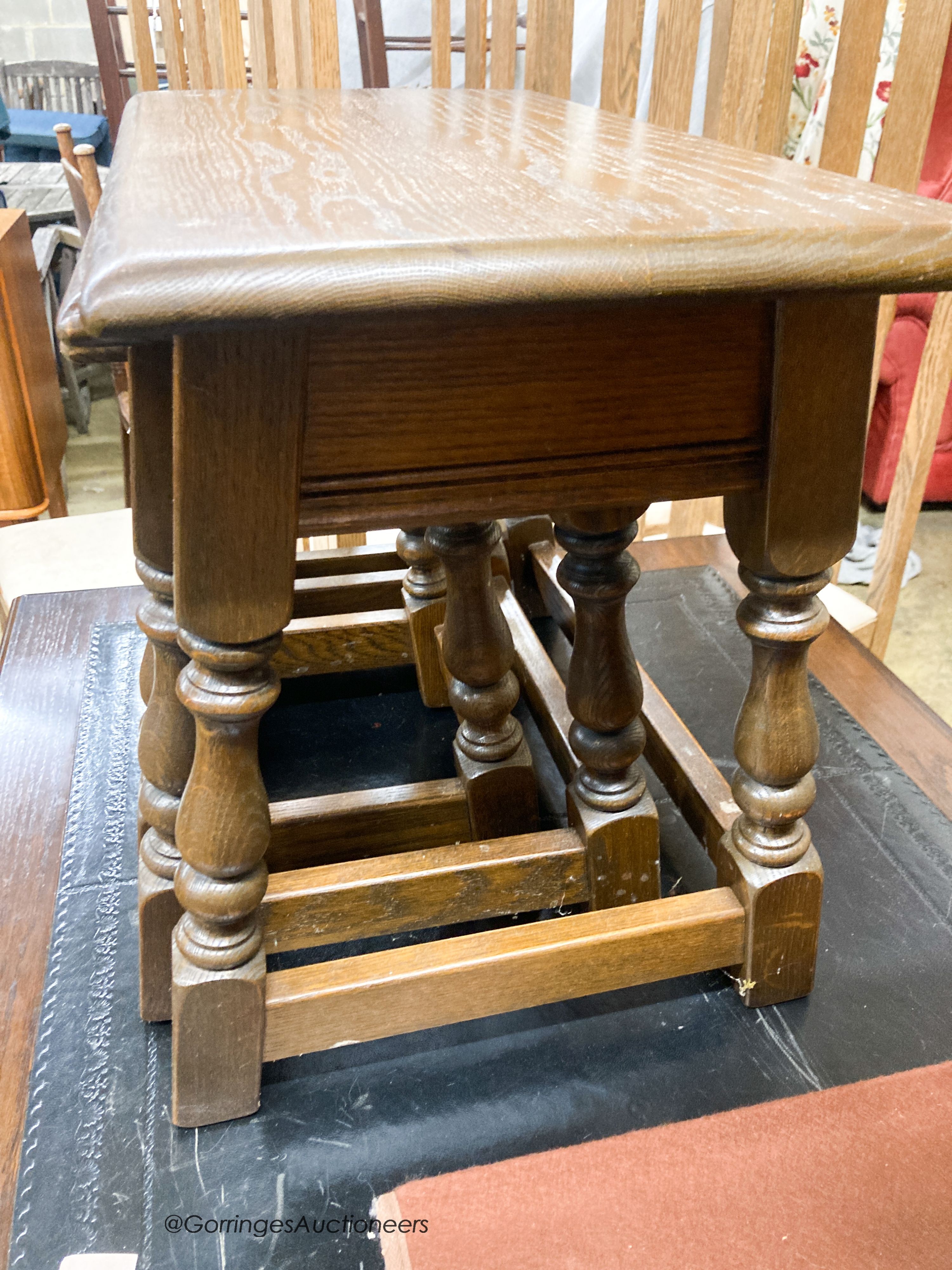 A nest of three reproduction rectangular oak tea tables, largest W.60cm W.32cm H.45cm